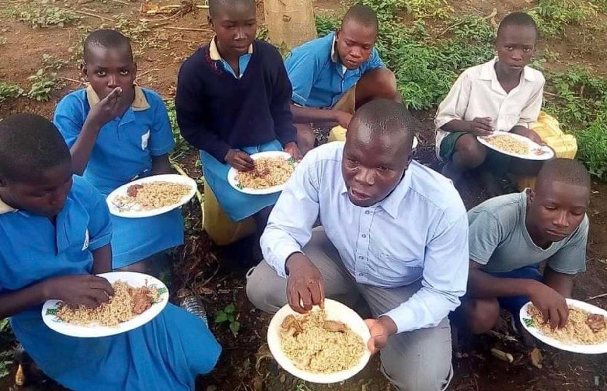 Children receiving meals in Uganda