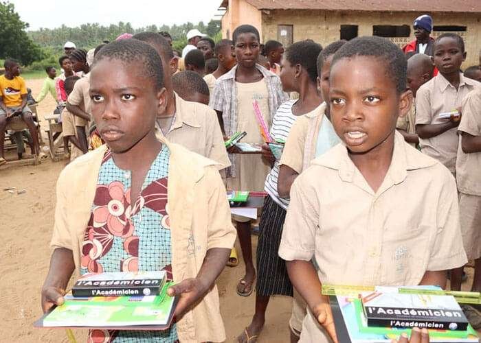Children with school materials in Uganda